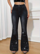 Black flare leg jeans with rhinestone embellished flare detailing featuring sparkling stars along the lower legs