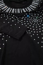 Black long sleeve bodysuit featuring sparkling silver rhinestones in a decorative pattern for elegant wear