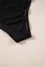 Black lace trimmed bottom of rhinestone long sleeve bodysuit with sheer mesh detailing in long sleeve bodysuit design