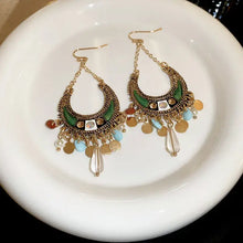 Ornate rhinestone resin alloy dangle earrings with green enamel and teardrops