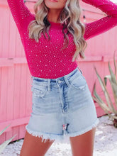 Fuchsia long sleeve sleeve bodysuit with round neck and white polka dots featuring rhinestone details