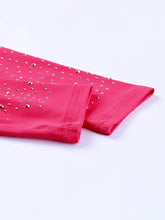 Pink stretchy rhinestone pants complementing a round neck long sleeve sleeve bodysuit for stylish wear