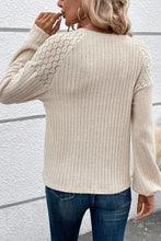 Women’s beige ribbed knit sweater with round neck and decorative button