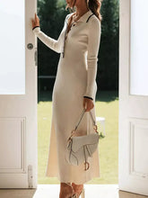 Cream-colored ribbed knit sweater dress with black trim and buttons