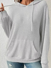 A soft light gray ribbed knit long sleeve drawstring hoodie with front pocket made of stretchy material machine wash cold