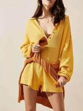 Yellow ribbed knit long sleeve romper with button-front over shorts