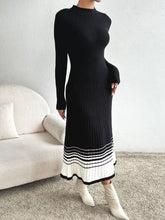 Black ribbed knit midi sweater dress with high neck, long sleeves, white striped hem