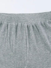 Gray ribbed knit pants with elastic waistband and product measurements