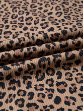 Tan corduroy ribbed leopard print zip hoodie featuring a bold black pattern and a slightly stretchy fabric for comfort