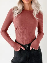 Ribbed long sleeve fitted bodysuit in muted terracotta with ribbed texture and fingerless cuffs