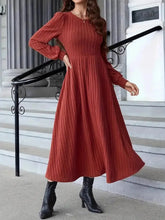 Ribbed rust-colored long-sleeve midi sweater dress with fitted bodice and flared skirt