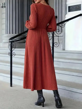 Ribbed rust-orange long sleeve sweater dress with puffed sleeves and fitted waist