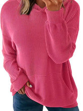 A vibrant pink ribbed oversized hoodie with long sleeves, slightly stretchy material, and a front pocket