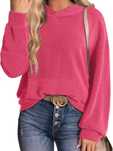 A vibrant pink ribbed oversized hoodie sweatshirt made from slightly stretchy knit with a cozy oversized fit and pocket