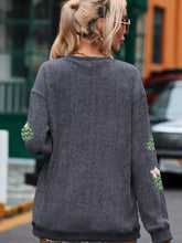 Dark gray corduroy ribbed round neck baggy sweatshirt with festive green and pink sequin christmas tree patches on sleeves