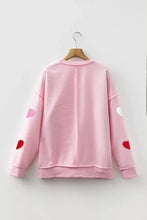 Pink striped ribbed texture chenille sweatshirt with colorful heart glitter trim patches on the sleeves