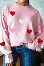 Pink ribbed chenille sweatshirt with red light pink and white heart patches and glitter trim long sleeves