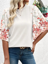 A white ribbed texture half sleeve blouse with pink red and green floral pattern puff sleeves patchwork top