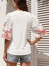 White ribbed texture half sleeve blouse with floral embroidery on sleeves and ribbed back side visible