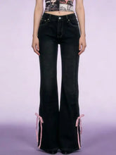Black high-waisted classic denim flare jeans with pink ribbon ties at the cuffs for a perfect fit