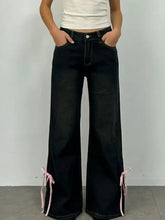 Black wide-leg classic denim flare jeans with pink tie details at the cuffs for a perfect fit