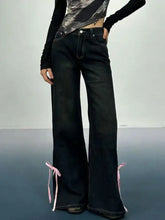 Black classic denim flare jeans with pink ribbon ties at the ankles offering a stylish perfect fit