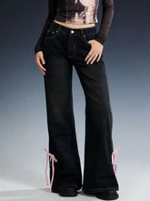 Black classic denim flare jeans with pink ribbon ties at ankles for a stylish perfect fit look