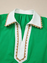 A vibrant green short sleeve blouse with white color block patchwork collar and ricrac trim accent