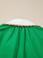 A vibrant green ricrac trim color block patchwork short sleeve blouse with a crisp white collar edged in gold trim