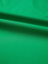 Smooth vibrant green fabric with subtle sheen and folds in ricrac trim color block patchwork short sleeve blouse