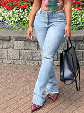 Light-wash denim ripped knee flare jeans with frayed hem showcasing stylish knee flare jeans detail