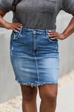 Risen Amelia mid-thigh length denim mini skirt with faded blue wash frayed hem and subtle distressing details