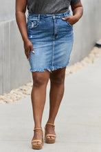 Risen amelia mid-thigh length denim mini skirt with faded blue wash frayed hem and subtle distressing details