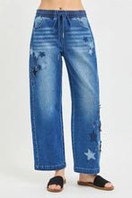 Blue denim cropped barrel jeans with risen elastic band waistband and star patch appliqués