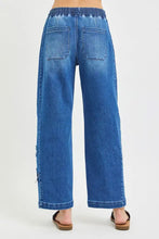 Blue denim wide-leg cropped barrel pants with risen elastic band and star patch featuring a relaxed fit