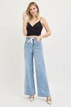 Light-wash denim high-rise slouchy wide jeans with elastic waistband and white drawstring for casual comfort