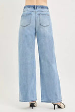 Light-wash denim slouchy wide jeans with high waist elastic band and classic back pockets shown from the back side