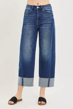 High-waisted blue denim RISEN full size slouchy crop barrel leg jeans with wide-leg cut and rolled cuffs plus size