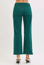 Back view of risen high rise ankle flare jeans in emerald green wide-leg denim with high waist and two patch pockets