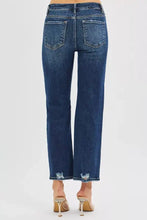Dark blue denim risen high rise slim straight jeans with high rise crop and distressed frayed hems and hidden knee patch