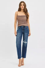 A pair of risen high rise crop slim straight dark wash denim jeans with intentional distressing and hidden knee patch