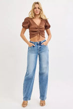 Brown ribbed crop top with puffed sleeves and front tie paired with risen high rise wide baggy jeans