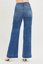 Blue denim risen high rise wide leg jeans with high rise wide flare, classic five-pocket design and rolled cuffs