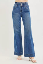 Risen high rise wide leg blue denim jeans featuring a high rise wide waistband and button closure