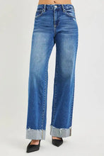 Blue denim risen high rise wide leg jeans with frayed cuffed hem and wide leg silhouette