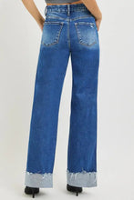 Blue denim risen high rise wide leg jeans with cuffed hem and frayed cuffs for a stylish casual look