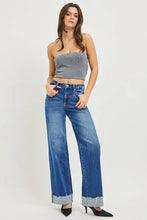 Blue denim risen high rise wide leg jeans with cuffed hem and frayed cuffs in a wide leg cut