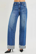 Blue denim RISEN high rise wide leg jeans with cuffed hem featuring rolled frayed edges for a stylish look
