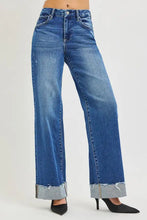 Risen high rise wide leg jeans in blue denim with a high-rise waist wide leg and frayed cuffed hem