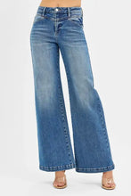Medium-wash blue denim risen high rise wide leg jeans with front yoke and heart back pocket design